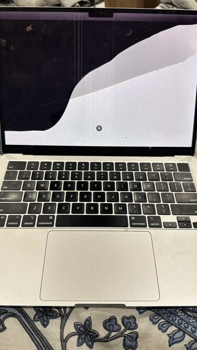 MacBook with a cracked, bleeding LCD screen before replacement